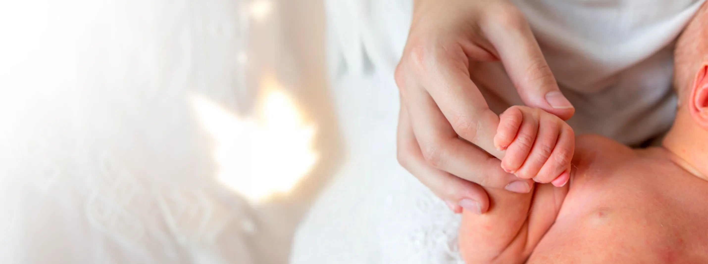 Close up of mother holding newborn baby hand, tender postpartum connection moment