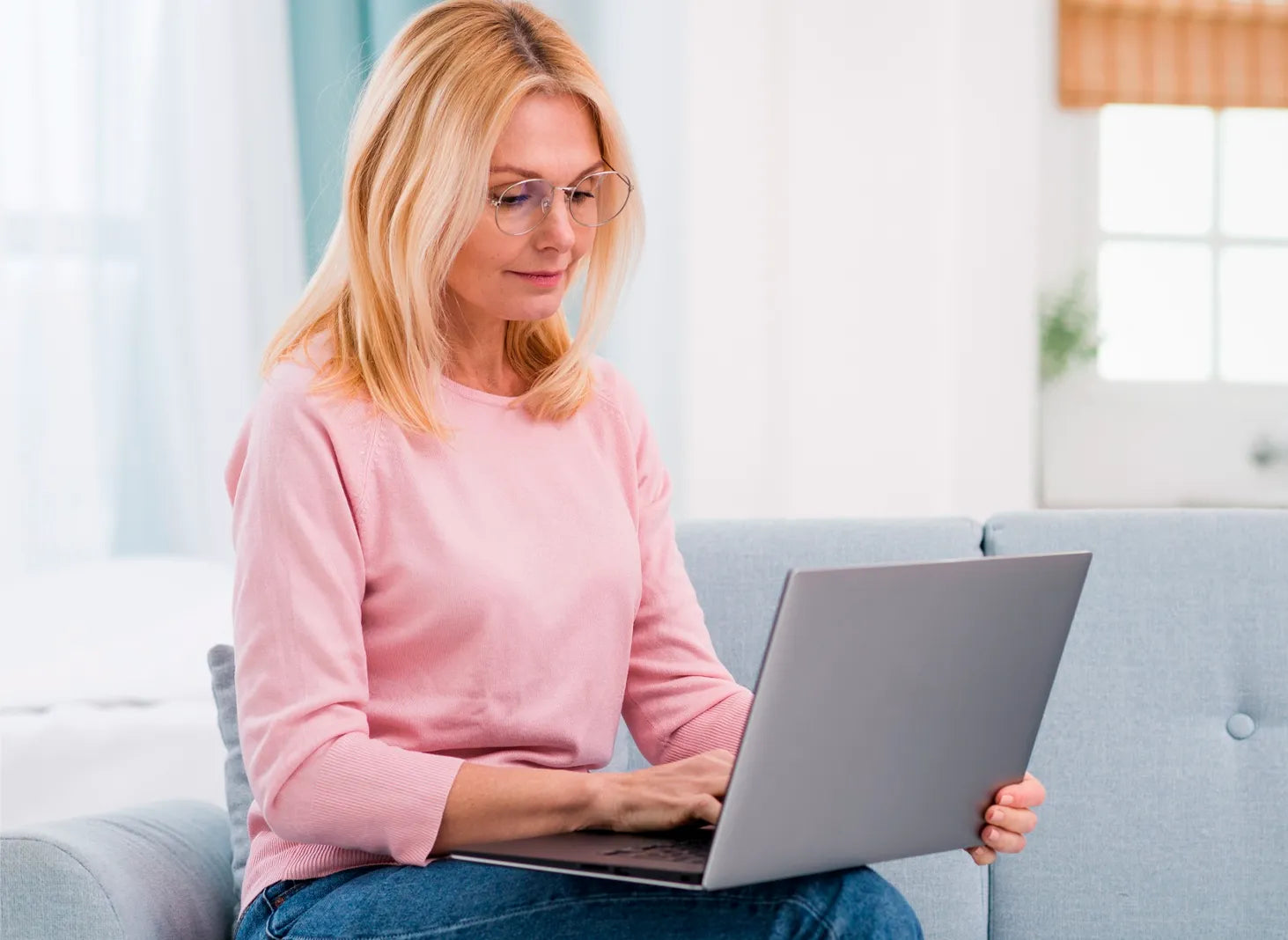 Woman using laptop at home, modern women’s wellness and lifestyle planning concept