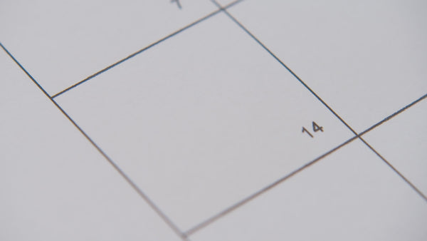 Pink heart placed on calendar date, pregnancy planning and fertility awareness concept