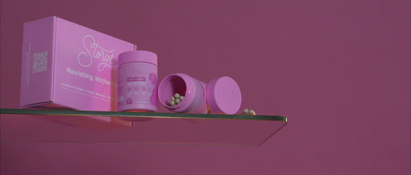 Premium pink prenatal vitamins supplement packaging with box and capsules on soft gradient background